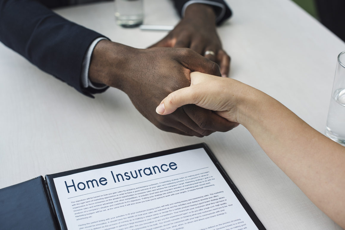 Two hands shaking hands over insurance in Bellflower