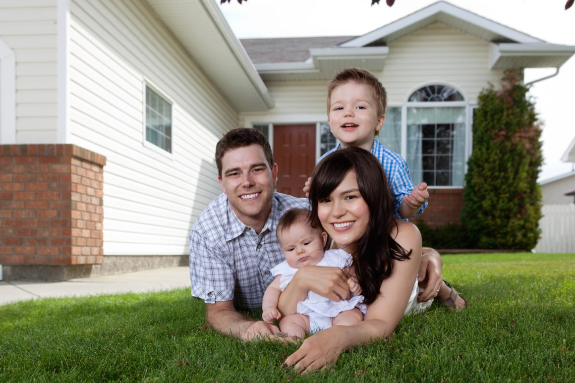 Family in front of a home with Home Insurance in Huntington Beach, Seal Beach, CA, Westminster, CA, and Surrounding Areas